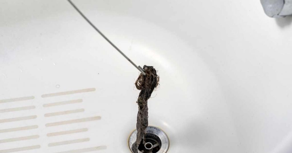 pulling hair from drains using a wire coat hanger