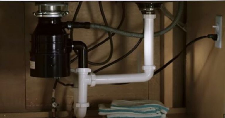 kitchen sink garbage disposal backing up into other side