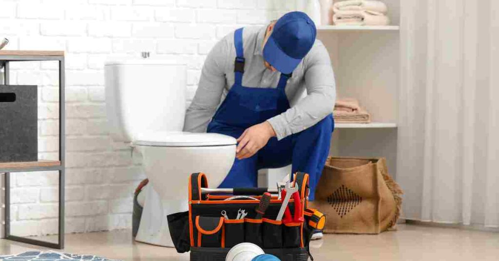 plumber fixing a toilet