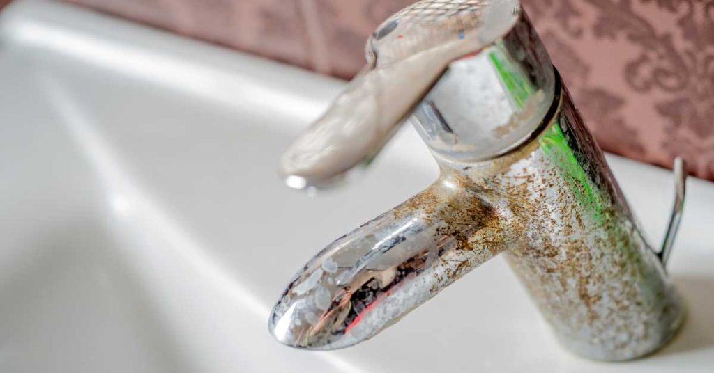 hard water deposits in bathroom faucet